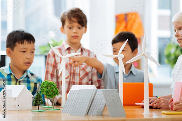 Fototapeta Figures. Cute smiling kids making paper figures while preparing a task for a lesson