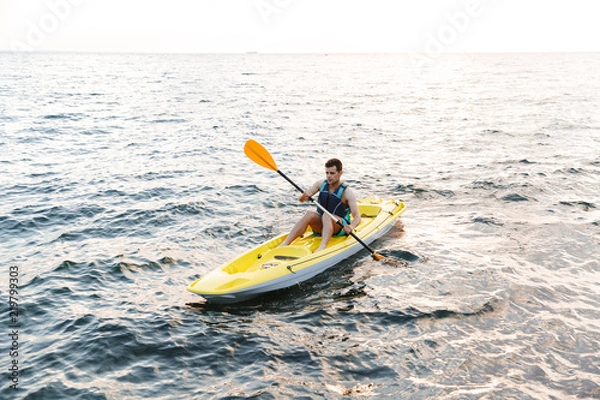 Fototapeta Man paddling the kayak