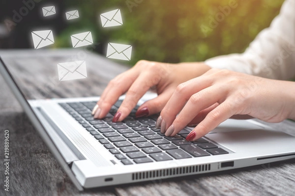 Fototapeta Business woman using Laptop pc to send e- mail with email icon, E-mail and communication concept..