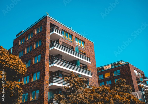 Obraz brick apartment house with warm colored trees