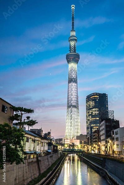 Fototapeta TOKYO, JAPAN - June 22, 2018: Tokyo Skytree, Sumida Ward Urban night scene. Tokyo Skytree tower reflections on the canal. Tokyo Sky Tree is one of the famous landmark in Tokyo.