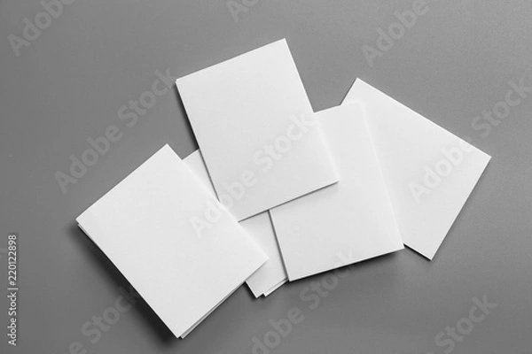 Fototapeta Blank portrait mock-up paper. brochure magazine isolated on gray, changeable background / white paper isolated on gray