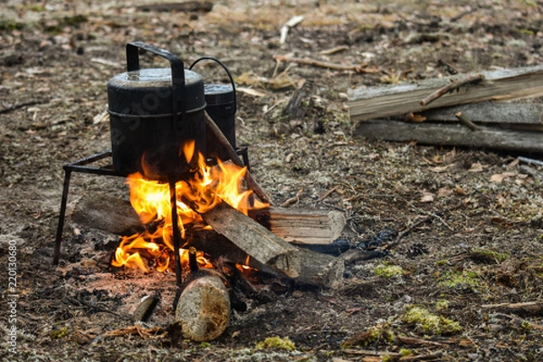 Fototapeta At the stake, soup is cooked and tea is heated. In nature in the hike