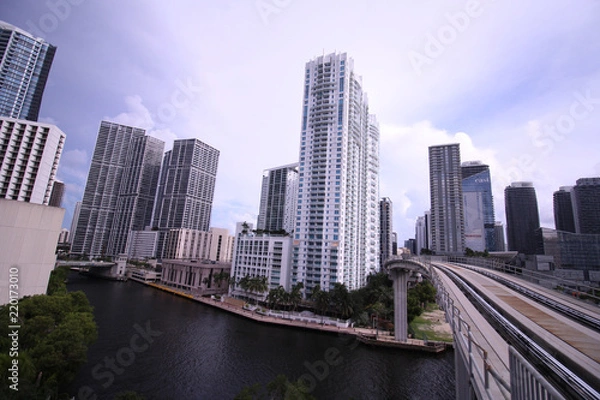 Obraz Cityscape of Miami Skyline with Tall Buildings and Train Bridge Over the River in Brickell