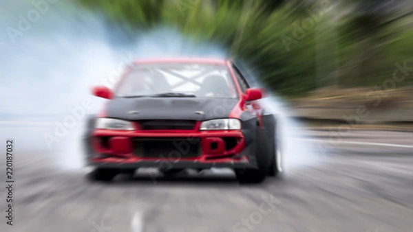 Fototapeta Side view car drifting on track with grain, Sport car wheel drifting and smoking on track.