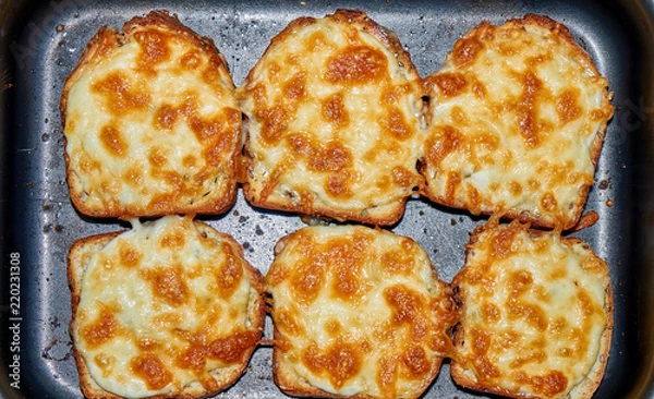Fototapeta Fried bread with cheese and mayonnaise on the black tray
