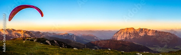 Fototapeta A Paraglider starts on the Lawinenstein to the Grimming. You have a beautiful view to Bad Mitterndorf in Salzkammergut Austria. 