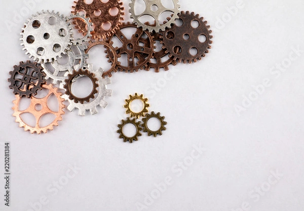 Fototapeta Different sizes and colored gears on a white background. Abstracts of business, education and knowledge concept
