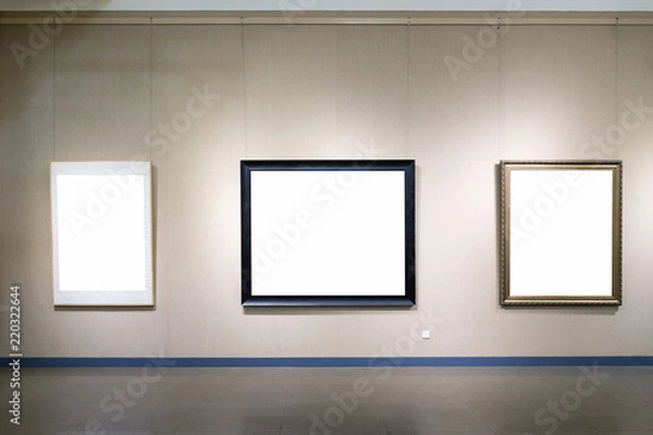 Fototapeta blank picture frames on wall