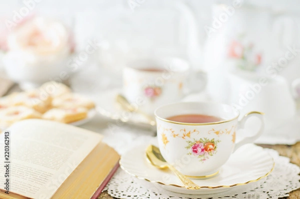 Fototapeta Close up of cup of tea on table with vintage tone