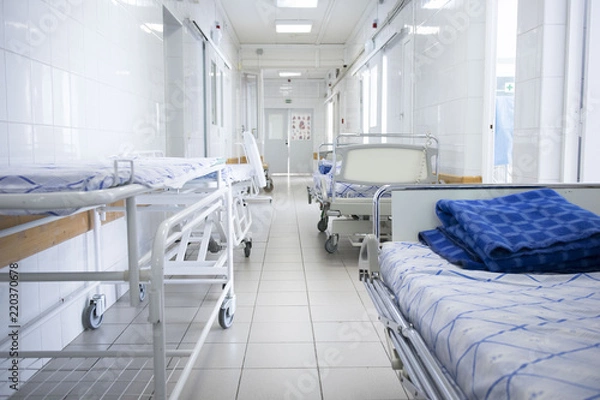 Fototapeta hospital bed rolling into the hallway of the hospital. concept of pandemic, coronavirus, virus, disinfection, panic.