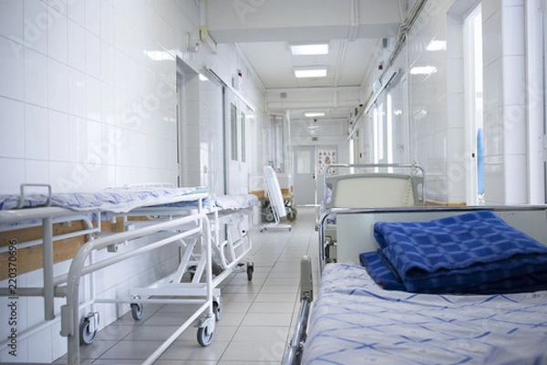 Fototapeta hospital bed rolling into the hallway of the hospital