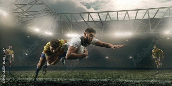 Obraz Rugby players fight for the ball on professional rugby stadium