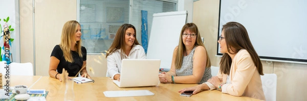 Fototapeta team of women preparing their business idea, meeting of female team in coworking. Blank screens for photomontage