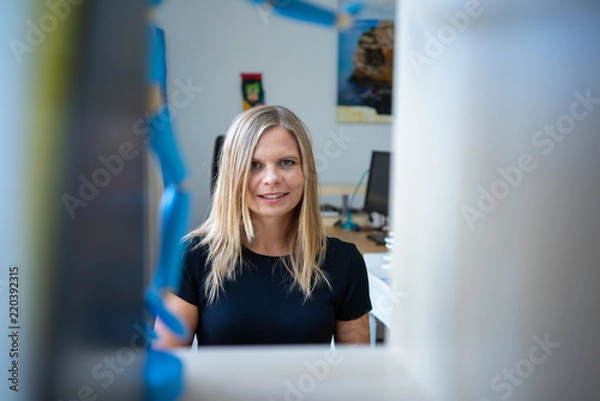 Fototapeta Young businesswoman with her computer, working in the coworking preparing her business idea