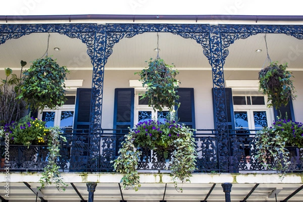 Obraz Black and White Balcony with Spring Flower Baskets Overlooking the French Quarter in New Orleans, Louisiana, USA