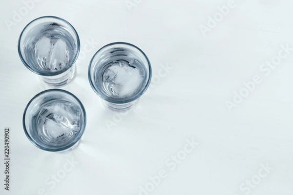 Fototapeta Vodka shots with ice on a white background