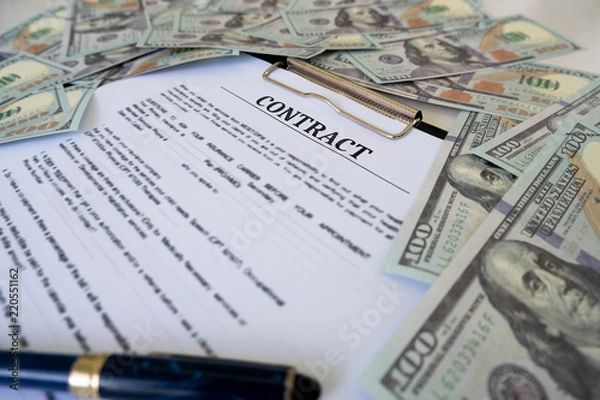 Fototapeta Sign contract for more money, US Dollar banknotes money on printed contract paper and pen to sign