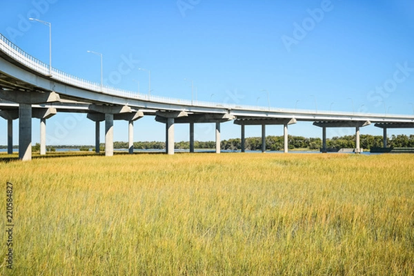 Obraz Long concrete bridge foundation crossing marsh area