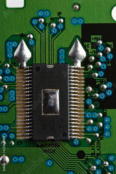 Fototapeta Microchip on green printed circuit board