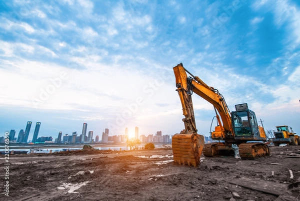Obraz excavator in construction site on sunset sky background