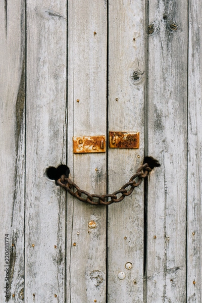 Obraz rusty chain locking an old wood door