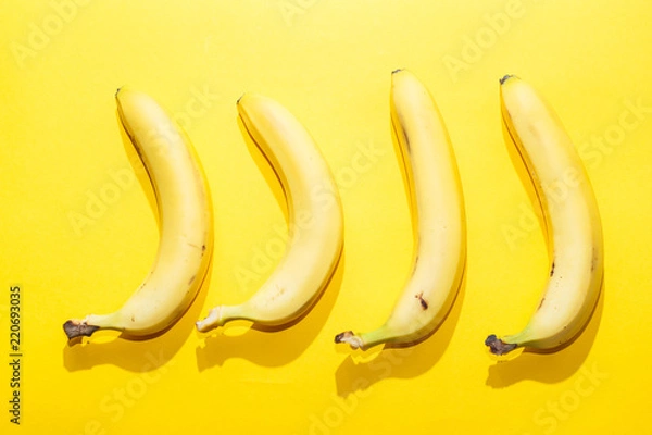 Fototapeta Bananas on yellow pastel background. minimal idea food concept