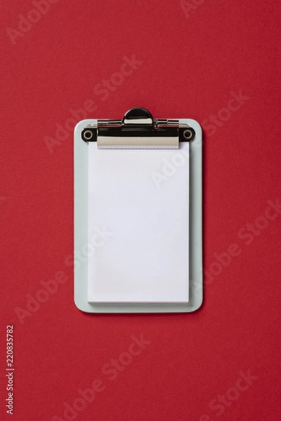 Fototapeta mockup Clipboard on red background. Flat lay, top view trendy for banner