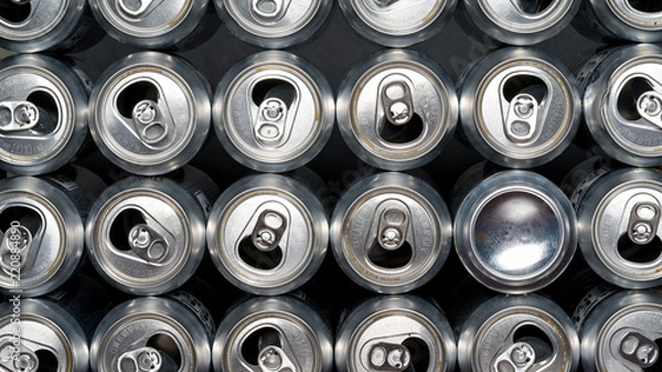 Fototapeta Stack of empty aluminum beer cans, front side view, close up, macro with one can being backwards. Be different from your herd.