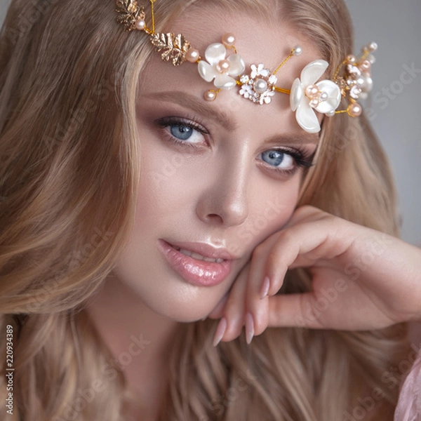 Obraz Delicate portrait of a young model girl. The image of the bride, a light lace dress in pink, a beautiful hairstyle and a natural make-up. Light photo studio, natural light from the window.