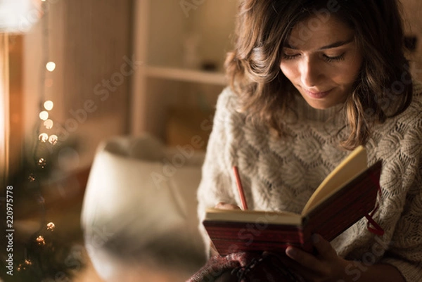 Obraz Woman writing on sketchbook