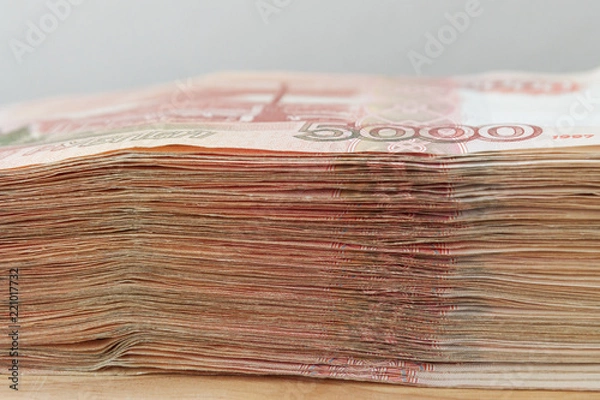 Obraz Big stack of Russian money banknotes of five thousand rubles lying on a wooden table