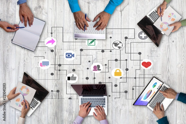 Fototapeta Business people from above working together in the office and using gadgets