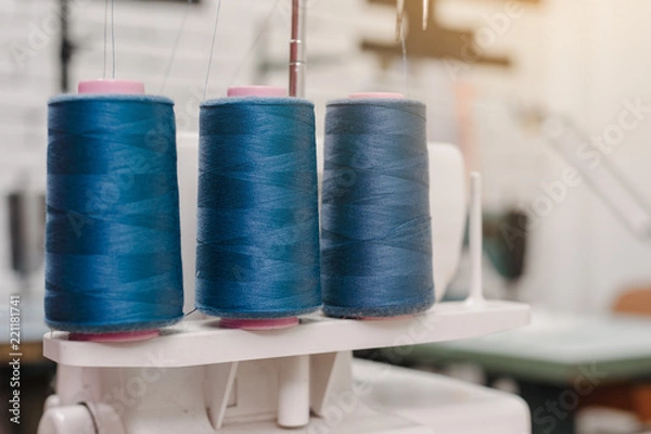 Fototapeta Closeup photo of threads coils on table in designer studio