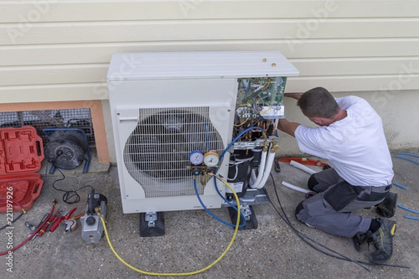 Fototapeta heat Pump. plumber at work installing a circulation heat pump