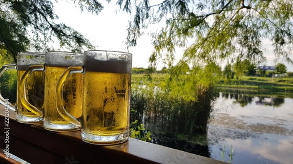 Obraz Serving cold draft beer over the lake