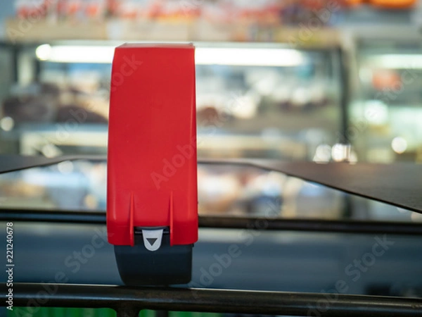 Fototapeta Ticket dispenser sitting in front of line at a local deli counter with copy space to right