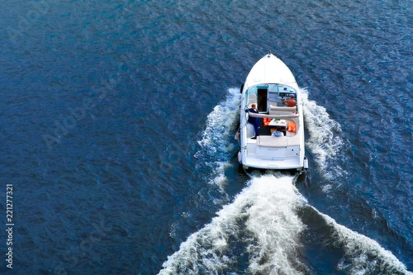 Fototapeta speedboat on the water in summer, back view
