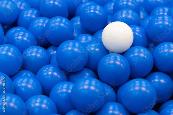 Obraz white plastic ball on blue plastic balls, concept : different, out standing