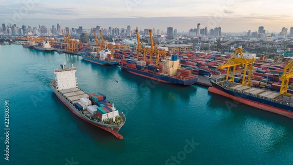 Obraz Container ship from sea port working for delivery containers shipment and container warehouse background. Suitable use for transport or import export to global logistics concept.