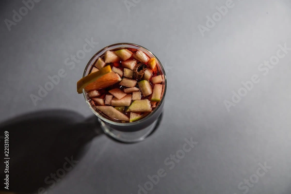 Fototapeta mulled wine, in a glass goblet on a gray background