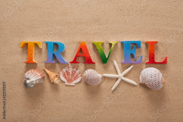 Fototapeta top view of travel written in colorful letters decorate with shellfish on the beach with copy space