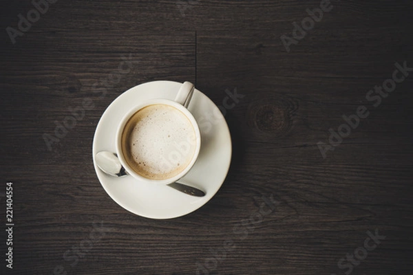 Obraz Closeup latte art of coffee white cup on wooden table surface