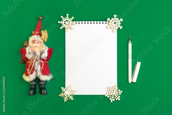 Fototapeta Postcard Happy New Year Flat lay composition with scroll and Christmas decor on green color background.Concept Letter for Santa Claus Greeting Top view Copy space Mock up Empty Text