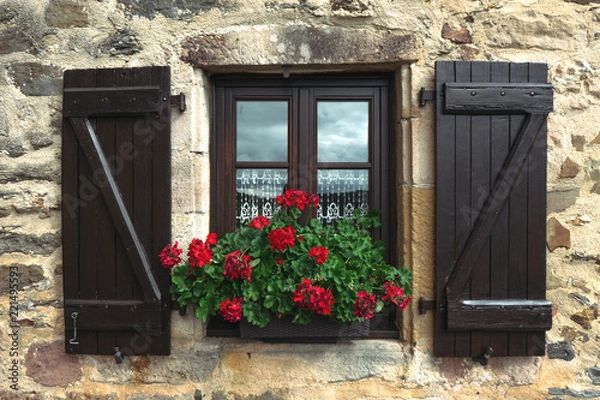 Obraz window with wood shutters and red geranium