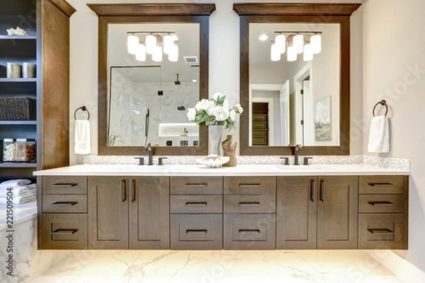 Fototapeta Master bathroom interior in luxury modern home with dark hardwood cabinets, white tub and glass door shower