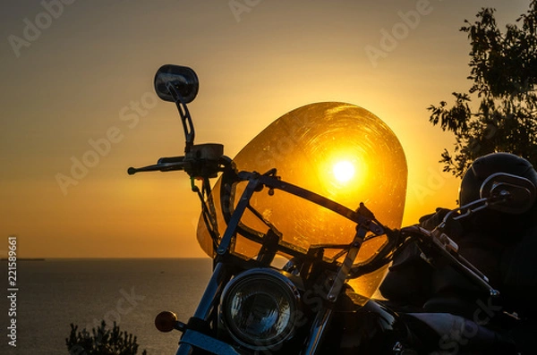 Fototapeta Motorcycle on a background of a beautiful summer sunset.