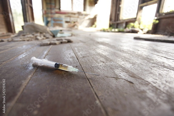 Fototapeta Syringe on the floor of an abandoned house.