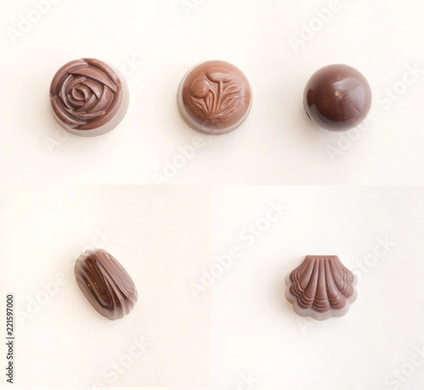 Fototapeta Chocolate sweets isolated / Collection of five different filled chocolates / Top view of chocolate candies isolated on white background with soft light and shadows