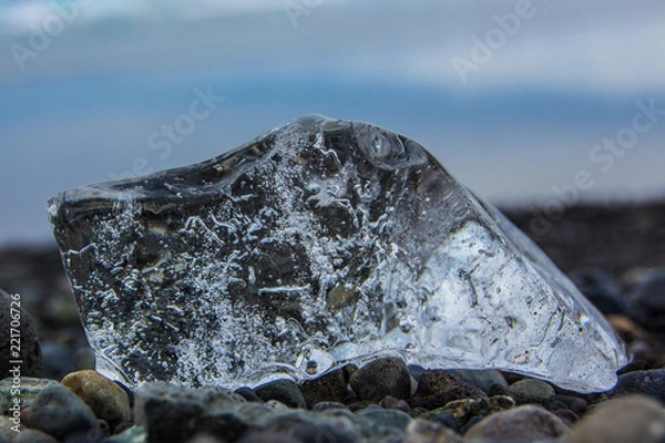 Obraz Close up of block of ice on pebbles